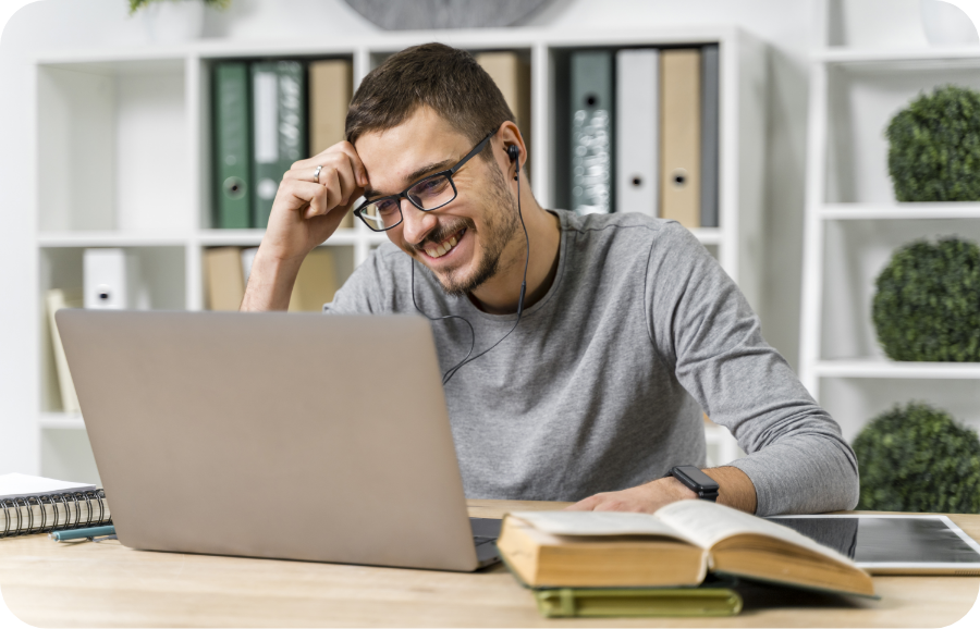 medium-shot-smiley-guy-studying-with-his-laptop